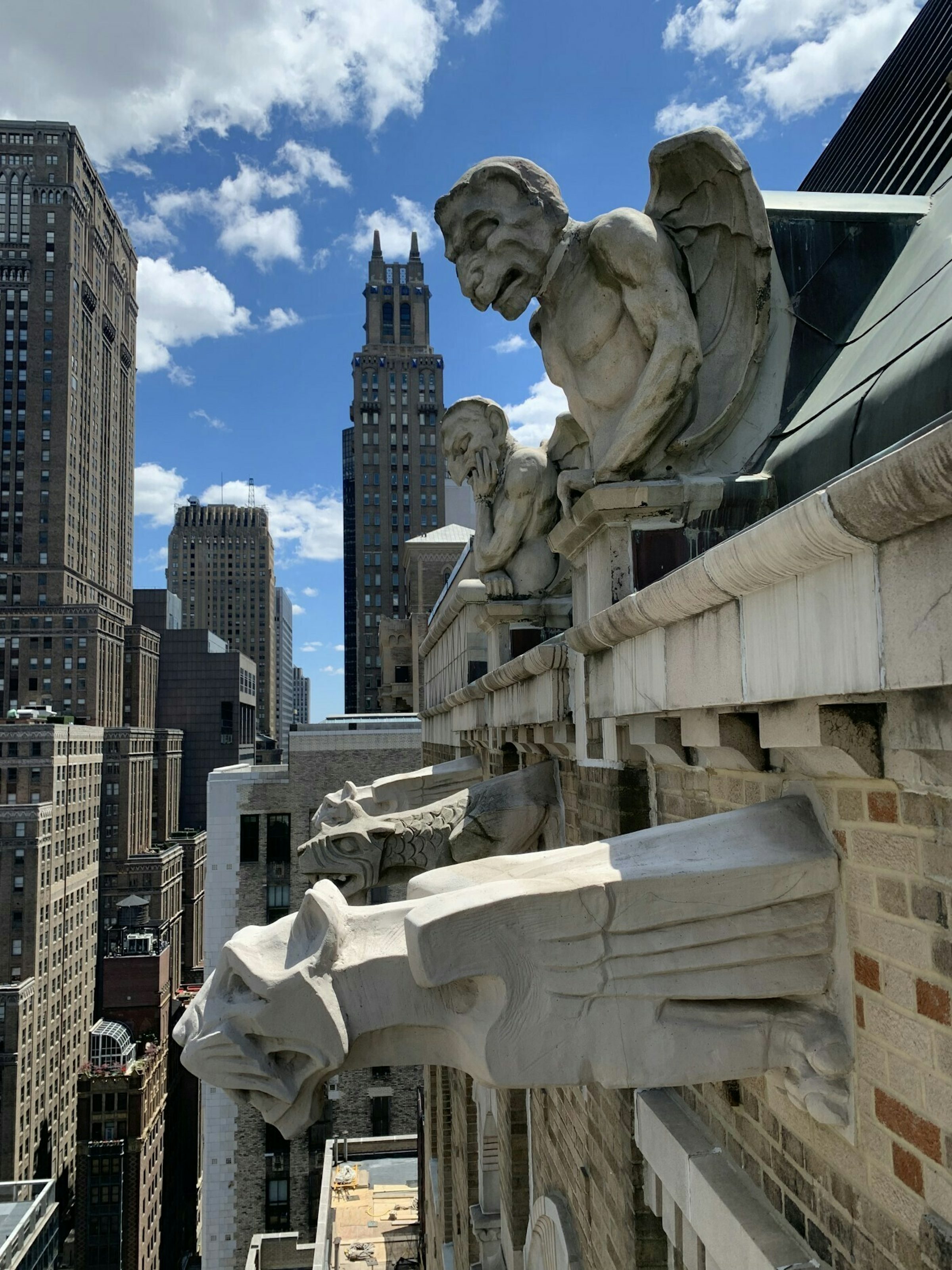 Gargoyles on the Farmers' Loan and Trust Company Building being inspected from rope.